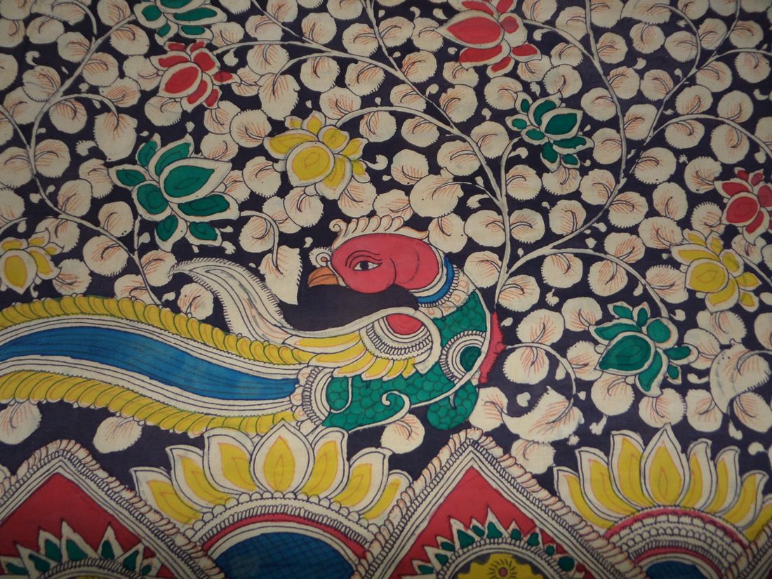 Detail of hand-painted Kalamkari cloth with a peacock and flowers